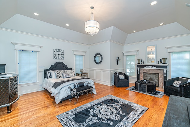 bedroom featuring a raised ceiling and light wood-type flooring