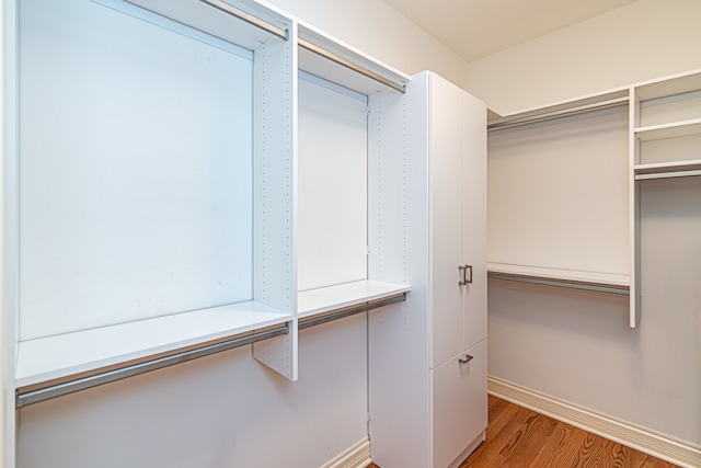 walk in closet with hardwood / wood-style floors