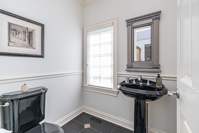 interior space featuring tile floors, sink, and toilet