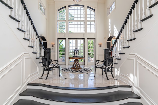 foyer entrance featuring a healthy amount of sunlight and a high ceiling