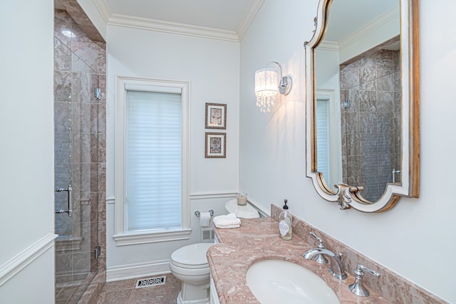 bathroom with crown molding, tile flooring, a shower with door, vanity, and toilet