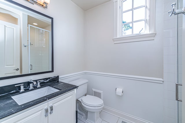 bathroom with tile floors, vanity, and toilet