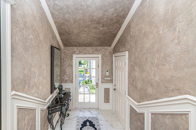 foyer featuring crown molding, lofted ceiling, and light tile floors