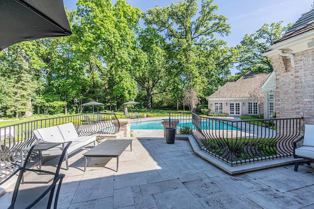 view of patio / terrace with a fenced in pool