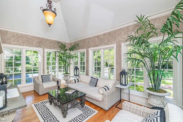 sunroom / solarium featuring a healthy amount of sunlight and lofted ceiling