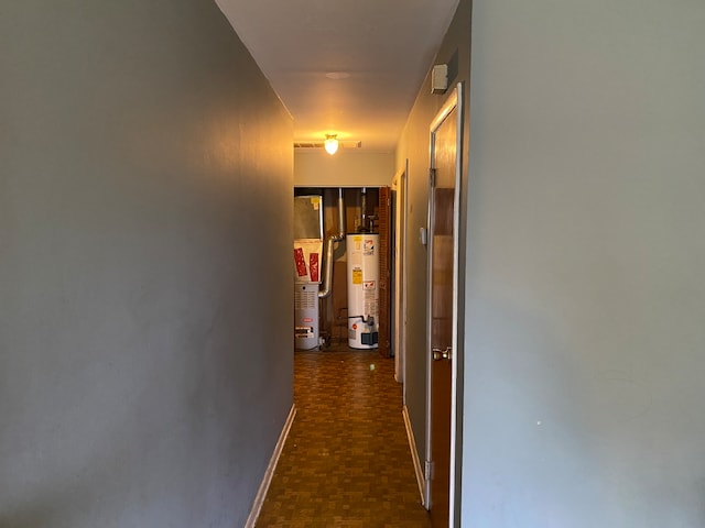 corridor with water heater and dark parquet floors