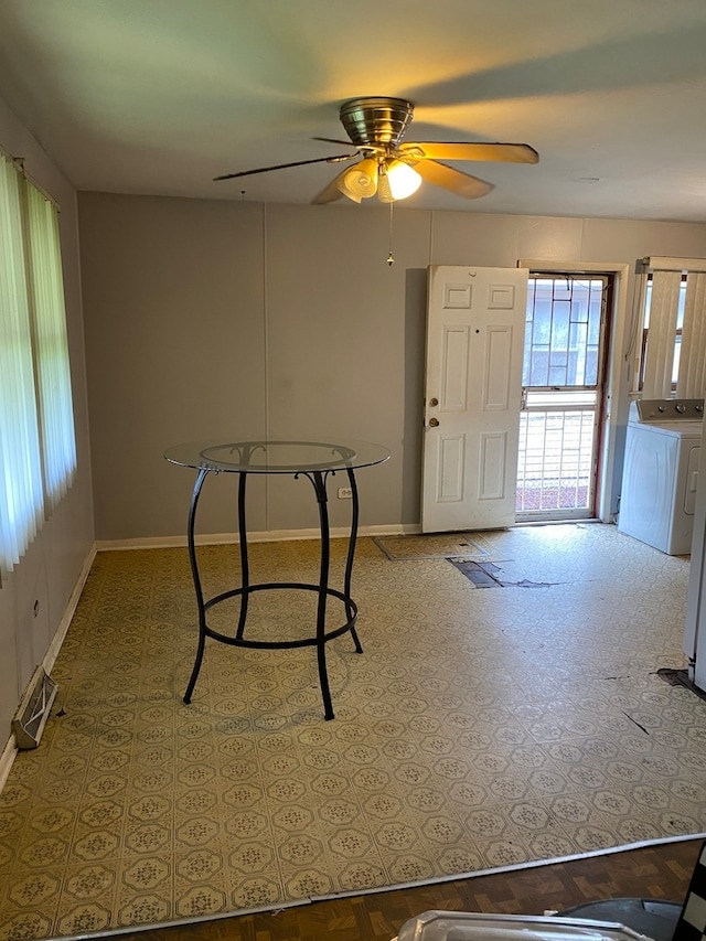 unfurnished dining area with ceiling fan and separate washer and dryer