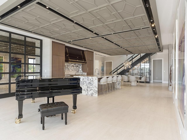 interior space featuring a sink, baseboards, and an ornate ceiling