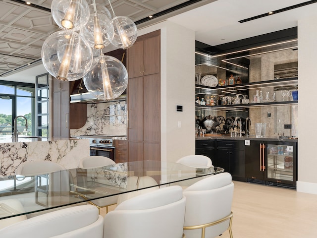 bar with sink, tasteful backsplash, and wine cooler