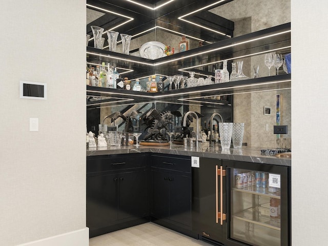 bar featuring wine cooler and wet bar