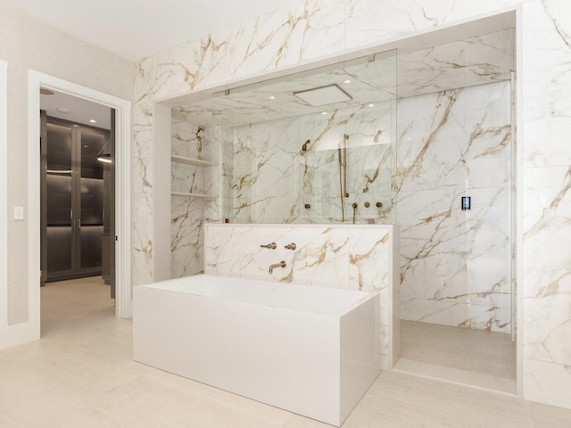 bathroom featuring a marble finish shower, a bathtub, and marble finish floor