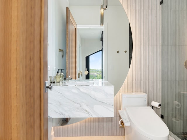 bathroom featuring toilet, an enclosed shower, and tile walls