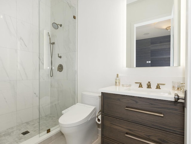 full bath featuring vanity, toilet, and tiled shower