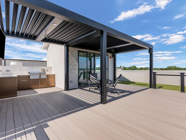 deck featuring exterior kitchen and area for grilling