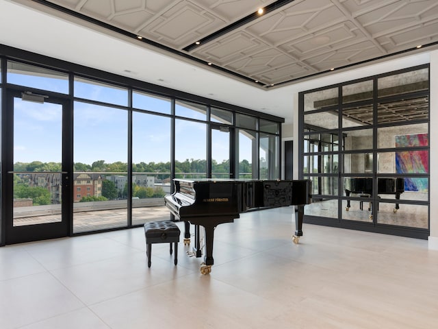 misc room with light tile patterned floors and expansive windows