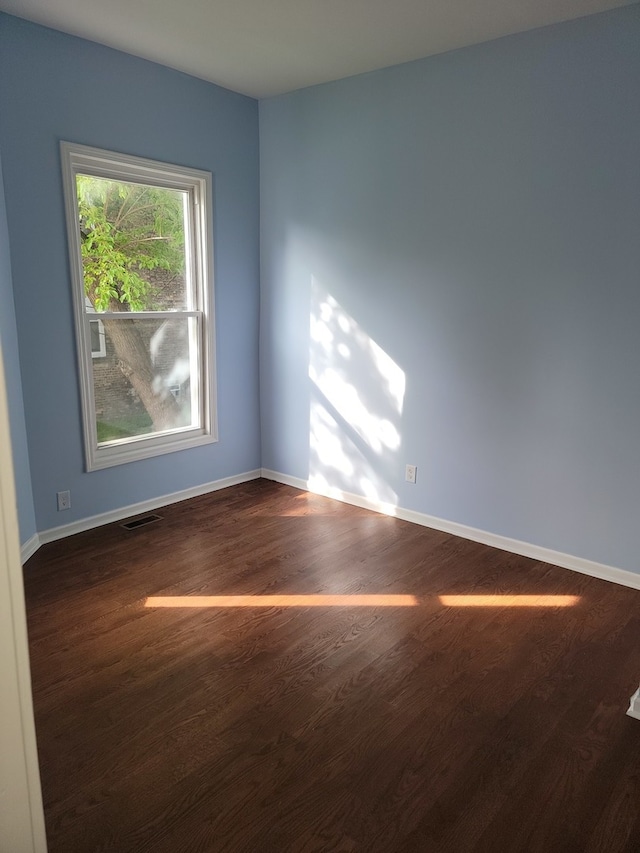 empty room with dark hardwood / wood-style floors