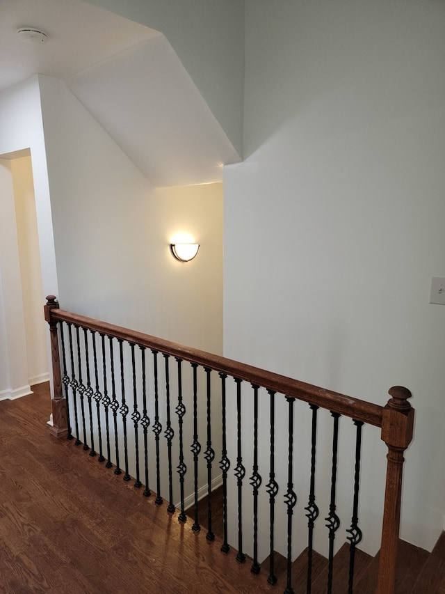 stairway with lofted ceiling and wood-type flooring