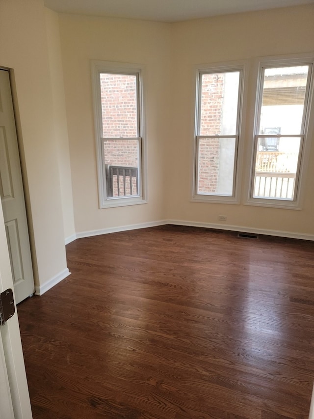 empty room featuring dark wood-type flooring