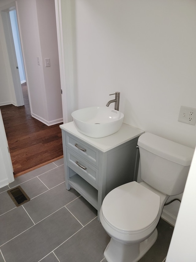 bathroom featuring vanity, toilet, and wood-type flooring