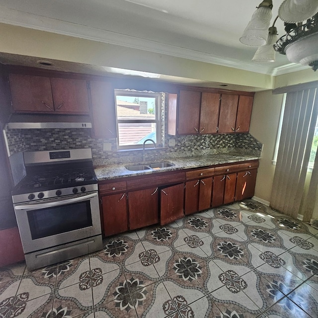 kitchen with stainless steel gas stove, sink, tasteful backsplash, and crown molding