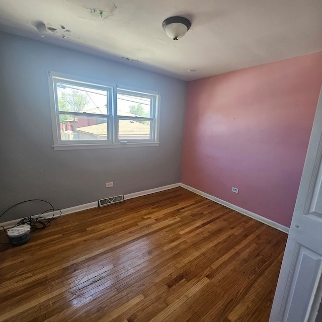 unfurnished room with dark hardwood / wood-style floors