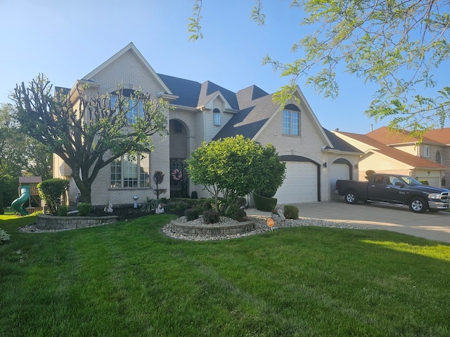 view of front of house with a front yard and a garage