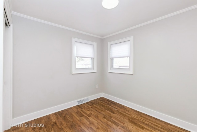 empty room with wood-type flooring and ornamental molding