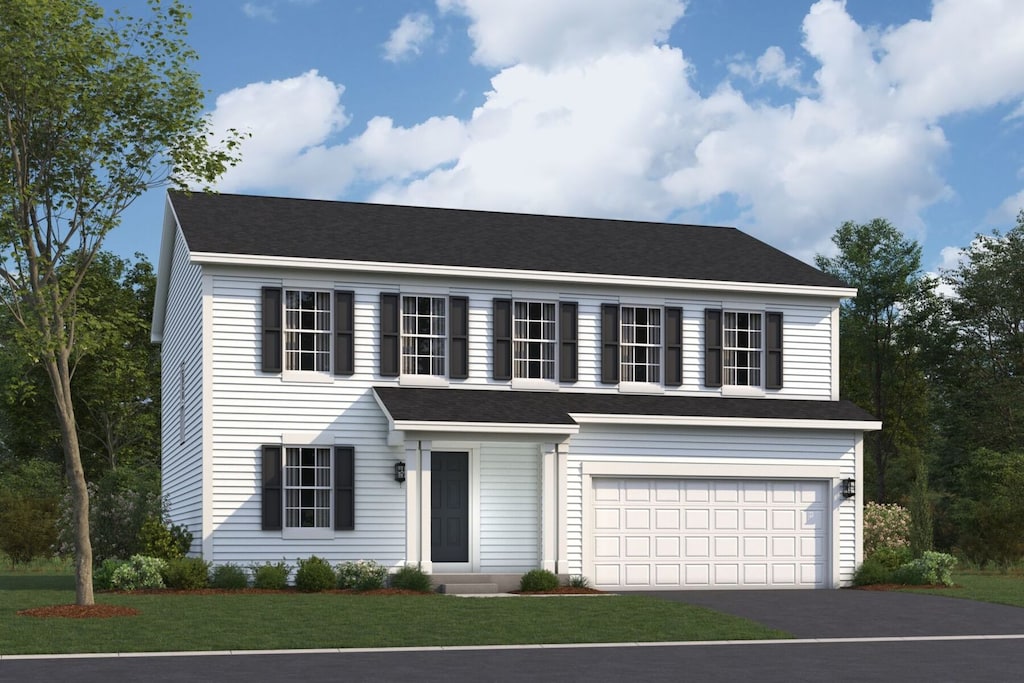 view of front of property with a front lawn and a garage