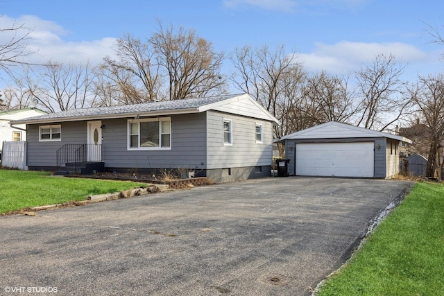 single story home with an outbuilding, a garage, and a front lawn