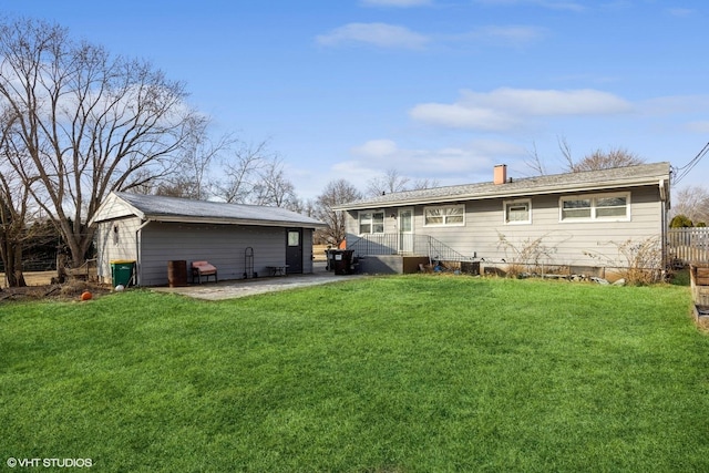 rear view of property featuring a lawn and a patio area