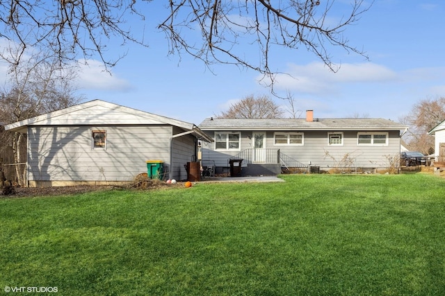 rear view of property with a yard