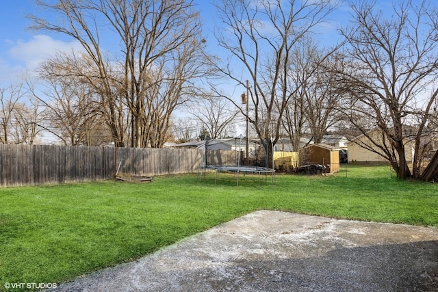 view of yard with a storage shed, a trampoline, and a patio area