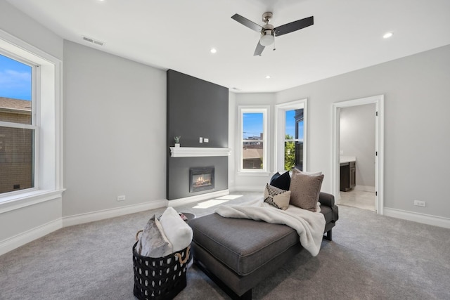 bedroom with ensuite bathroom, ceiling fan, and light colored carpet