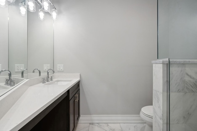 bathroom featuring vanity, toilet, and walk in shower