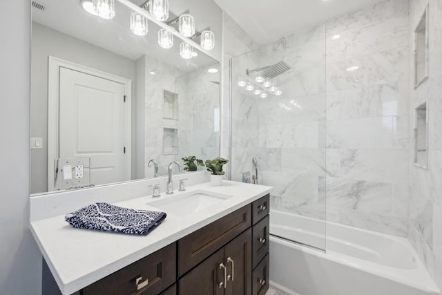 bathroom with vanity and tiled shower / bath combo