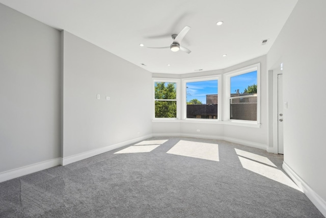 unfurnished room with ceiling fan and carpet floors