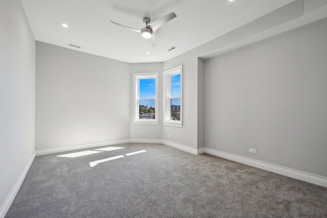 spare room featuring carpet flooring and ceiling fan