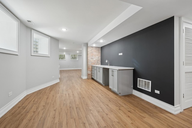 kitchen featuring light wood-type flooring and sink