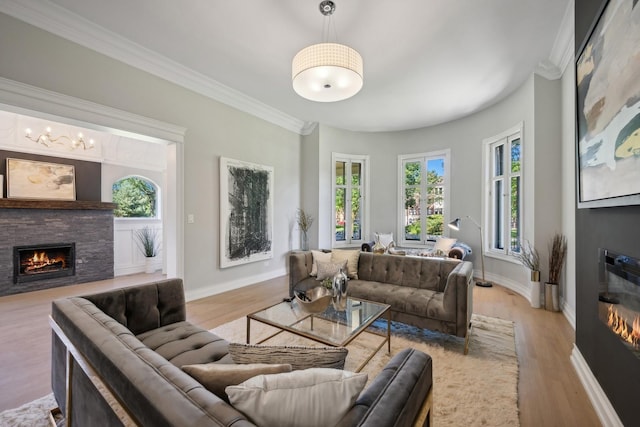 living room with a fireplace, light wood-type flooring, and ornamental molding