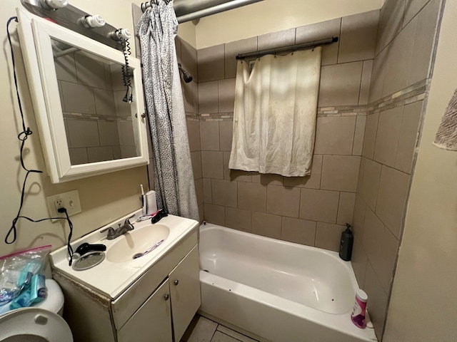 bathroom featuring tile patterned flooring, vanity, and tiled shower / bath combo