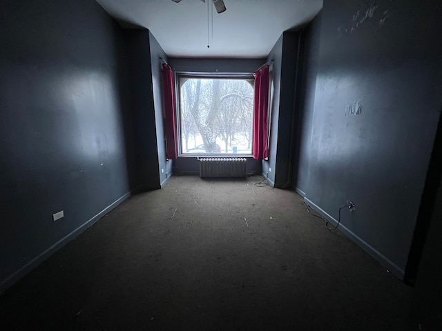 spare room featuring radiator heating unit and ceiling fan