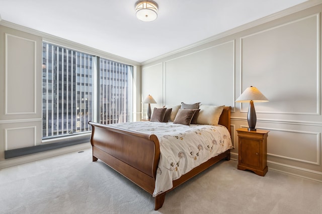 carpeted bedroom featuring crown molding