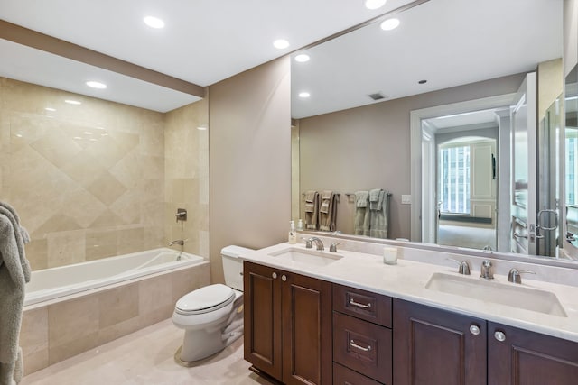 full bathroom featuring vanity, toilet, and tiled shower / bath