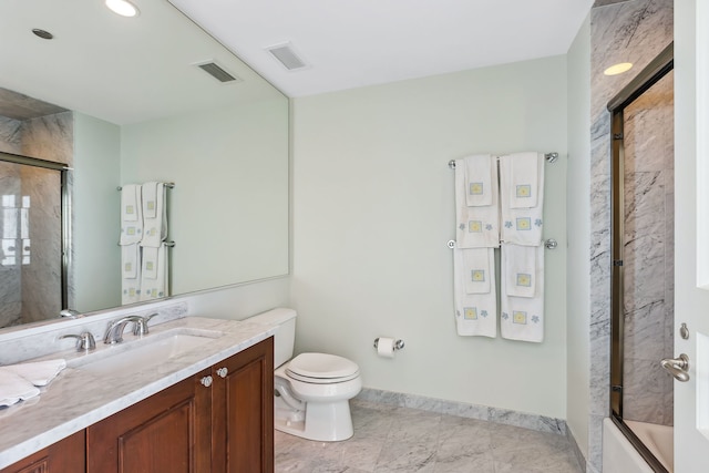 full bathroom featuring vanity, toilet, and shower / bath combination with glass door