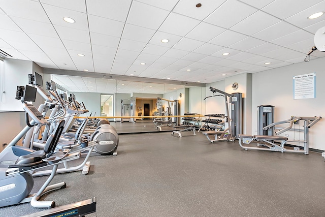 gym with a paneled ceiling