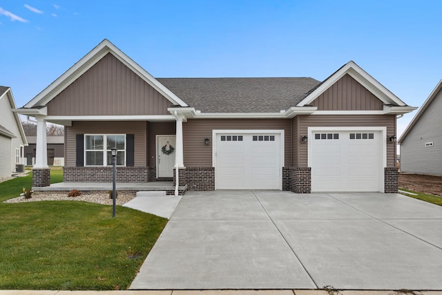 craftsman-style house featuring a front yard, a garage, and central AC