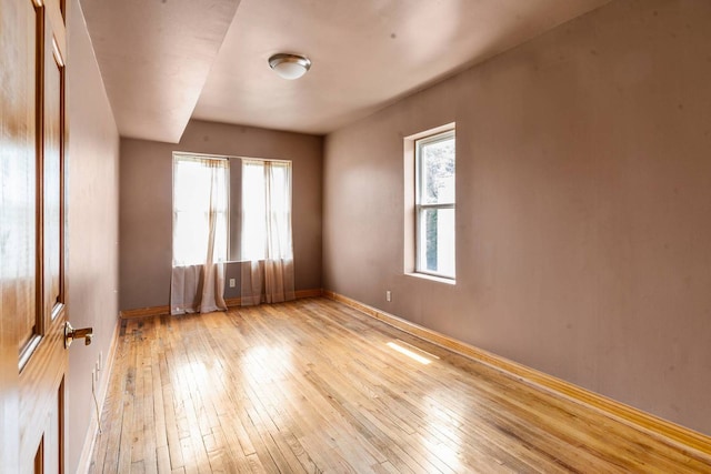 empty room with light hardwood / wood-style flooring