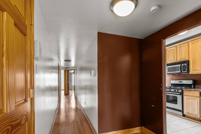 hall with light tile patterned floors