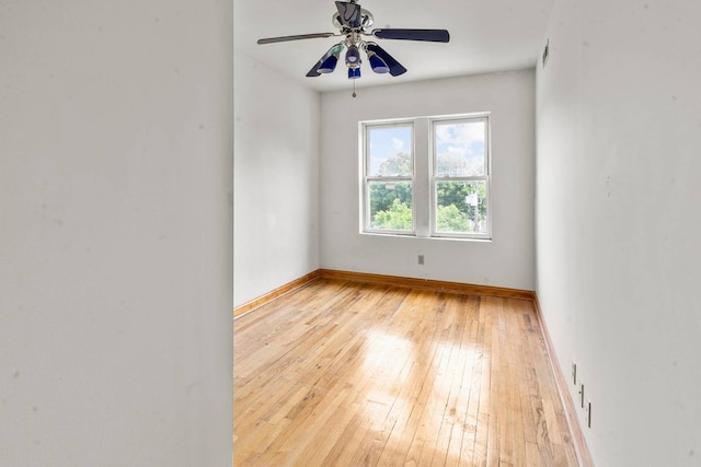 empty room with ceiling fan and light wood-type flooring