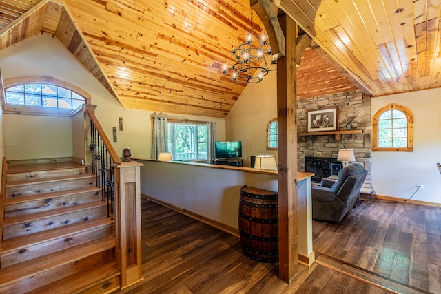 stairs featuring a notable chandelier, hardwood / wood-style flooring, a fireplace, and wood ceiling